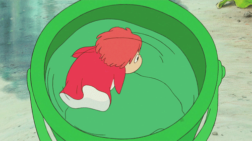 Anime character Ponyo in her fish form, circling a green bucket in a looping gif.